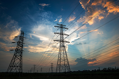 Electricity Pylon power line transmission tower at sunset