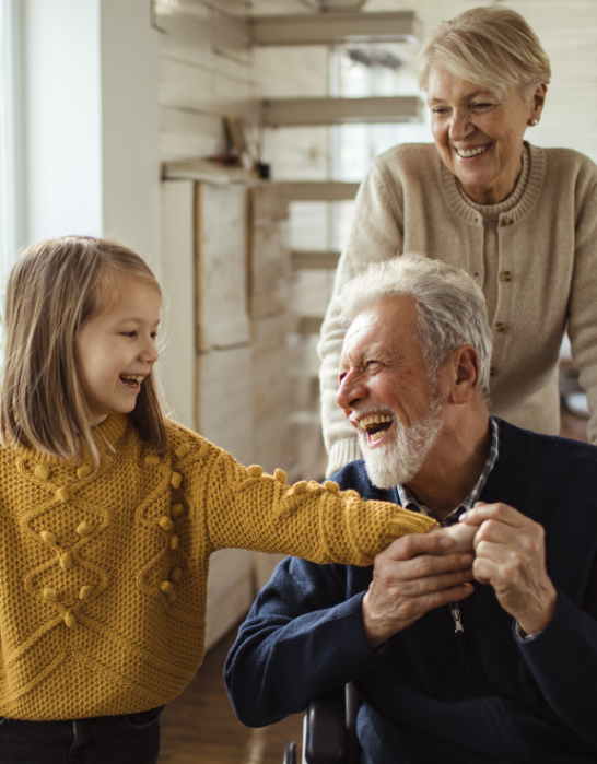 Grandparents laugh with grandchild