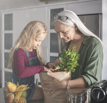 Grandma and grandchild looking at groceries