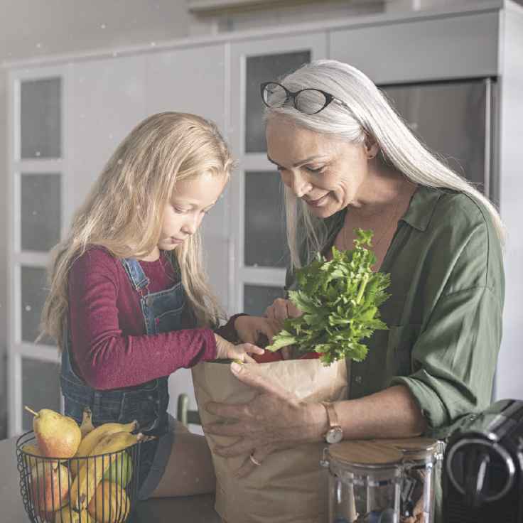 Grandma and grandchild looking at groceries