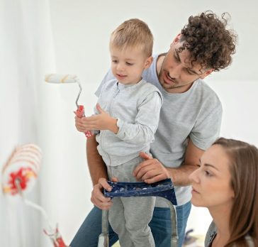 Family painting interior of house