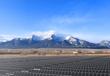 Solar panel field in front of mountains