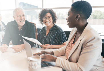 Group of people smiling in a meeting