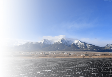Solar panel field in front of mountains