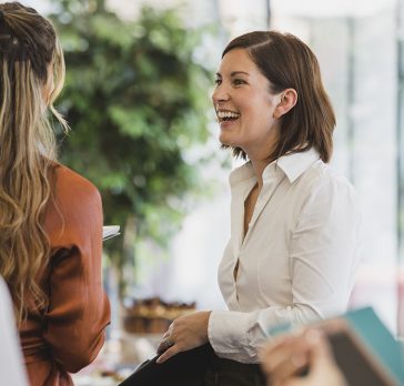 Cheerful colleagues laughing during corporate event