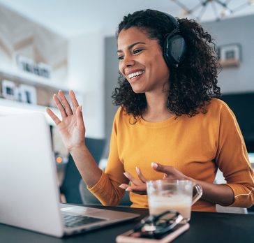 Young modern woman having Video Conference at home