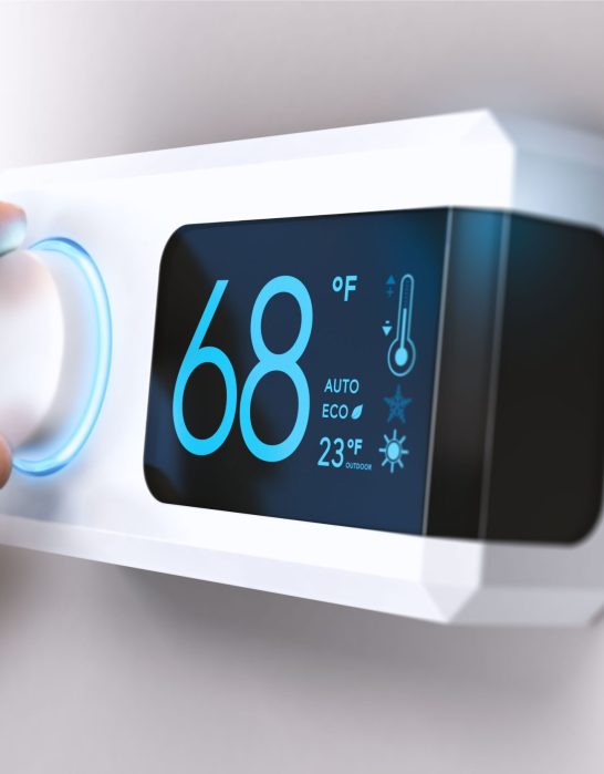Hand turning a home thermostat knob