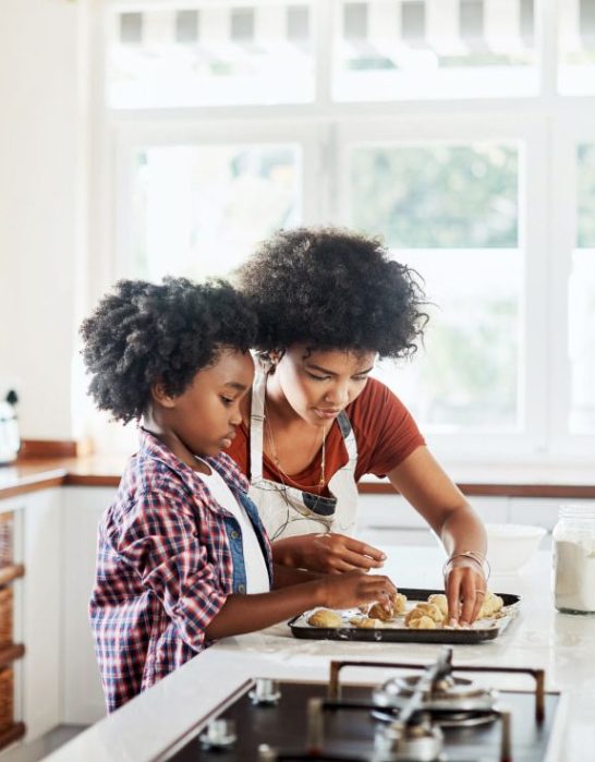Shot of a mother and son baking together in the kitchen