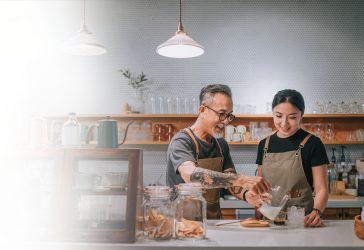 Man teaching daughter how to make coffee