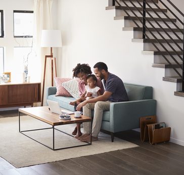 Family smiling looking at a laptop