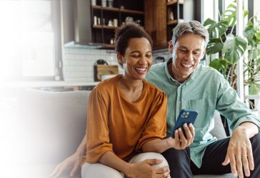 Couple_viewing_phone_from_couch