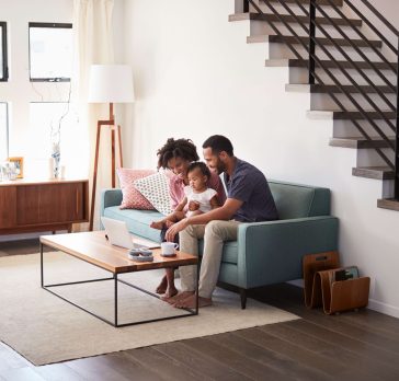 couple in living room looking at computer