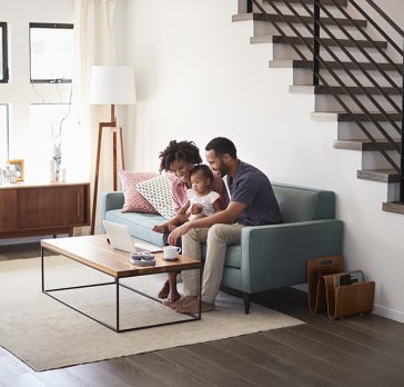 Couple on couch looking at computer