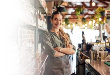 Young lady working behind a cafe bar