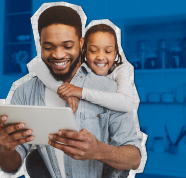 Daughter hugging father while he looks at tablet.